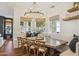Bright dining area featuring large windows, a stylish chandelier, and comfortable seating at 2625 N 24Th St # 15, Mesa, AZ 85213