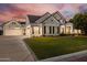 Beautiful home featuring a manicured lawn, attached garage, and elegant architectural design, showcasing curb appeal at 2625 N 24Th St # 15, Mesa, AZ 85213