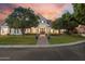 Charming home with manicured lawn, mature shade trees, and a brick walkway leading to a welcoming entry at 2625 N 24Th St # 15, Mesa, AZ 85213