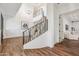 Open concept foyer showcasing a stairway with iron railings and a chandelier hanging from the ceiling at 2625 N 24Th St # 15, Mesa, AZ 85213