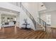 Stairway in the foyer features iron railings, light gray carpet and a decorative table with flowers at 2625 N 24Th St # 15, Mesa, AZ 85213