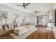 Spacious living room featuring a large comfortable sofa, hardwood floors, and access to a rear living space at 2625 N 24Th St # 15, Mesa, AZ 85213
