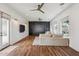 Open living room with hardwood floors, modern ceiling fans, built in shelving and large windows at 2625 N 24Th St # 15, Mesa, AZ 85213