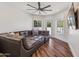 Spacious living room features hardwood floors, recessed lighting, ceiling fan, and large sectional sofa at 2625 N 24Th St # 15, Mesa, AZ 85213