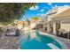 Tranquil backyard with a pool, spa, built-in BBQ, lounge area, and mature trees at 2625 N 24Th St # 15, Mesa, AZ 85213