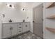 This bathroom features double sinks, black hardware, white cabinets, and tiled floor at 313 N 101St Way, Mesa, AZ 85207