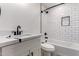 This bathroom features a shower with white subway tile and black trim, a vanity, and toilet at 313 N 101St Way, Mesa, AZ 85207