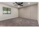 This bedroom features a modern ceiling fan, neutral walls and carpet, and a large window at 313 N 101St Way, Mesa, AZ 85207