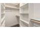This walk-in closet offers shelving and hanging storage at 313 N 101St Way, Mesa, AZ 85207