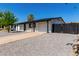 Inviting single-story home with desert landscaping, a well-manicured front yard, and a two-car garage at 313 N 101St Way, Mesa, AZ 85207