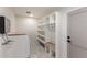 This laundry room features built-in storage and bench seat at 313 N 101St Way, Mesa, AZ 85207