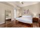 Spacious bedroom with wood floors, neutral walls, and a large mirror reflecting the bed at 3131 N Central Ave # 3004, Phoenix, AZ 85012