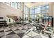 Bright and airy gym with modern equipment, high ceilings, and a geometric black and white patterned floor at 3131 N Central Ave # 3004, Phoenix, AZ 85012