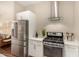 Modern kitchen with stainless steel appliances, white cabinets, and a gas range at 3131 N Central Ave # 3004, Phoenix, AZ 85012