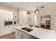 Bright kitchen with stainless steel appliances, a quartz countertop island with seating, and modern pendant lights at 3131 N Central Ave # 3004, Phoenix, AZ 85012