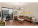 Cozy living room featuring hardwood floors, a modern light fixture, and a balcony view at 3131 N Central Ave # 3004, Phoenix, AZ 85012
