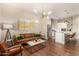Bright living room with a modern light fixture, hardwood floors, and an open layout to the kitchen at 3131 N Central Ave # 3004, Phoenix, AZ 85012