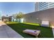 Fun outdoor game area with manicured artificial turf and cornhole game at 3131 N Central Ave # 3004, Phoenix, AZ 85012