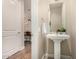 Chic powder room with a pedestal sink, decorative mirror, and neutral paint at 3131 N Central Ave # 3004, Phoenix, AZ 85012