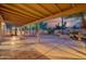 Covered back patio with mature landscaping, an outdoor fireplace, and fountain at 3204 N Jay St, Chandler, AZ 85225