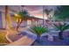 Landscaped backyard with covered patio, fountain, and mature landscaping at 3204 N Jay St, Chandler, AZ 85225