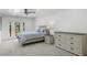 Bright bedroom with white walls, carpeted floors, a double door, and modern furniture at 3204 N Jay St, Chandler, AZ 85225