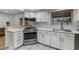 Kitchen features white cabinets, stainless steel appliances and a pass through to another living area at 3204 N Jay St, Chandler, AZ 85225