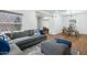 Open concept living and dining area featuring wood floors, gray sofa and modern furnishings at 3204 N Jay St, Chandler, AZ 85225