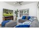 Bright living room with hardwood floors, gray sectional sofa, ceiling fan, and a large window at 3204 N Jay St, Chandler, AZ 85225