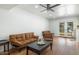 Bright open space featuring hardwood floors, a ceiling fan, neutral-toned seating and an exit to the back yard at 3204 N Jay St, Chandler, AZ 85225
