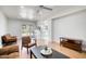 Bright open space featuring hardwood floors, a ceiling fan, neutral-toned seating and an opening to another area at 3204 N Jay St, Chandler, AZ 85225