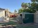 Fenced backyard featuring a lawn, gardening area, shed, mature trees, and blue skies at 3734 W Dailey St, Phoenix, AZ 85053