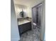 Bathroom featuring modern vanity, mirror and sink, modern tile work, and a glass enclosed shower at 3734 W Dailey St, Phoenix, AZ 85053