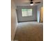 Cozy bedroom featuring neutral carpet, ceiling fan, and a window providing natural light at 3734 W Dailey St, Phoenix, AZ 85053