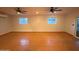 Spacious bonus room featuring tile flooring, two ceiling fans and natural light from a sliding glass door at 3734 W Dailey St, Phoenix, AZ 85053