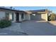 Single-story home featuring a driveway, two-car garage, desert landscaping, and solar panels at 3734 W Dailey St, Phoenix, AZ 85053