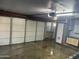 Spacious garage featuring a multi-car door, workbench, and storage cabinets at 3734 W Dailey St, Phoenix, AZ 85053