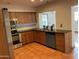 Kitchen view with tile floors, knotty pine cabinetry, stainless appliances, and backyard access at 3734 W Dailey St, Phoenix, AZ 85053