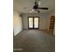 Neutral living room featuring carpeting, ceiling fan, and French doors to pool area at 3734 W Dailey St, Phoenix, AZ 85053