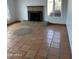 Living room features a brick fireplace, tile flooring and a large window with natural light at 3734 W Dailey St, Phoenix, AZ 85053