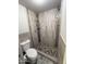 Modern bathroom shower with decorative tile and flooring with tiled walls and handheld shower at 3734 W Dailey St, Phoenix, AZ 85053