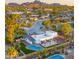 Stunning aerial view of a property with a sparkling pool, lush landscaping, and mountain views at 4040 E Becker Ln, Phoenix, AZ 85028