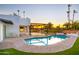 Stunning pool and outdoor patio at dusk at 4040 E Becker Ln, Phoenix, AZ 85028