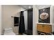 Modern bathroom featuring a walk-in shower with black and white tiling and a stylish vanity with a round mirror at 4040 E Becker Ln, Phoenix, AZ 85028