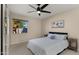 Bright bedroom with a large window offering backyard views, complemented by neutral tones and comfortable furnishings at 4040 E Becker Ln, Phoenix, AZ 85028