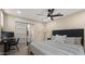 Cozy bedroom with ceiling fan, desk, and ensuite bathroom at 4040 E Becker Ln, Phoenix, AZ 85028