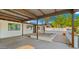 View from inside the carport, showing the entrance, desert landscaping, and pebble accents at 4040 E Becker Ln, Phoenix, AZ 85028