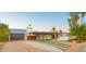 Beautiful desert home with a long driveway, carport, and unique desert landscaping at 4040 E Becker Ln, Phoenix, AZ 85028