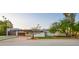 Stunning home with an attached carport, manicured lawn and mature trees at 4040 E Becker Ln, Phoenix, AZ 85028