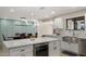 Modern kitchen featuring an island with a wine cooler, stylish lighting, and an adjacent dining area at 4040 E Becker Ln, Phoenix, AZ 85028